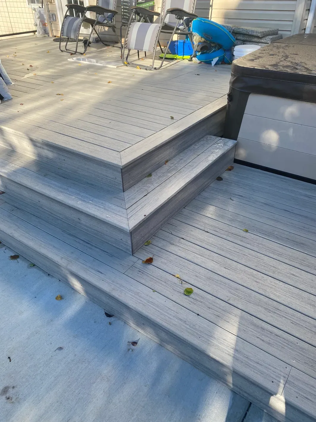 Outdoor deck with hot tub and chairs